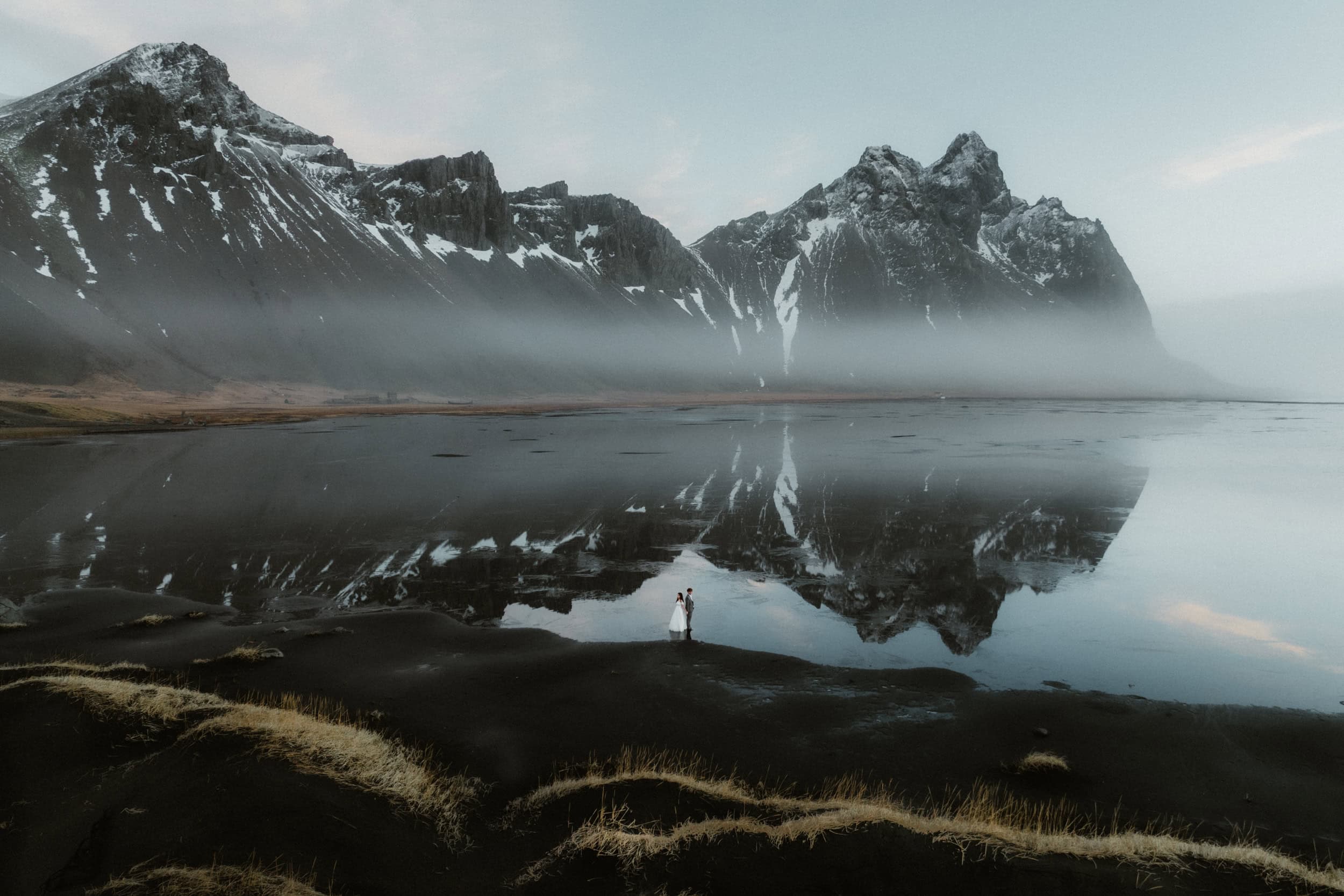 Beautiful Icelandic landscape with towering mountains reflected in a calm lake, perfect for elopement photography.
